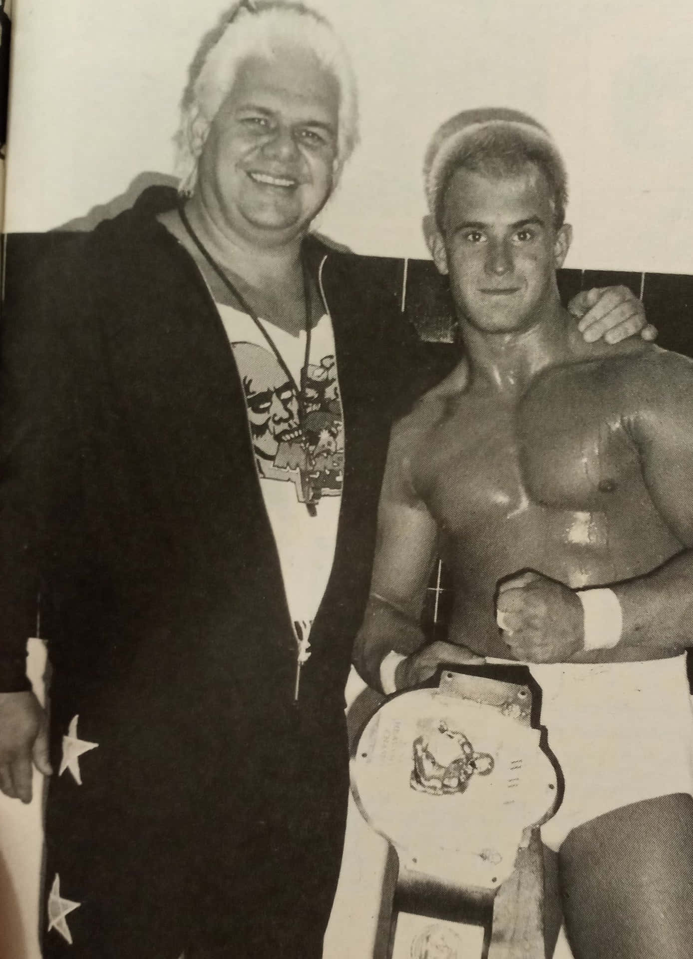 Wrestling_ Champions_ Posing_ With_ Belt Background
