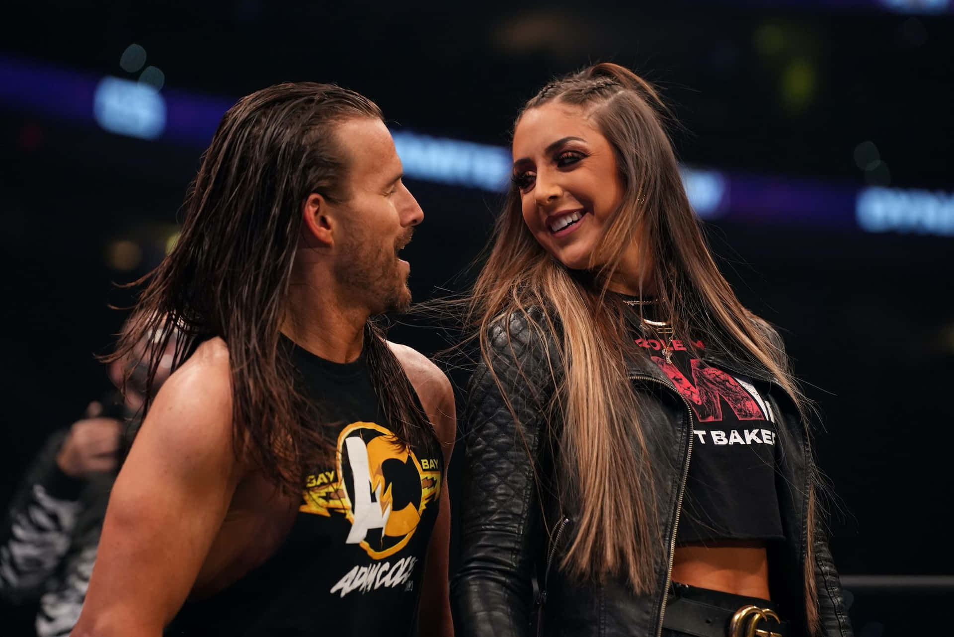 Wrestling Personality Adam Cole Posing With Britt Baker Background