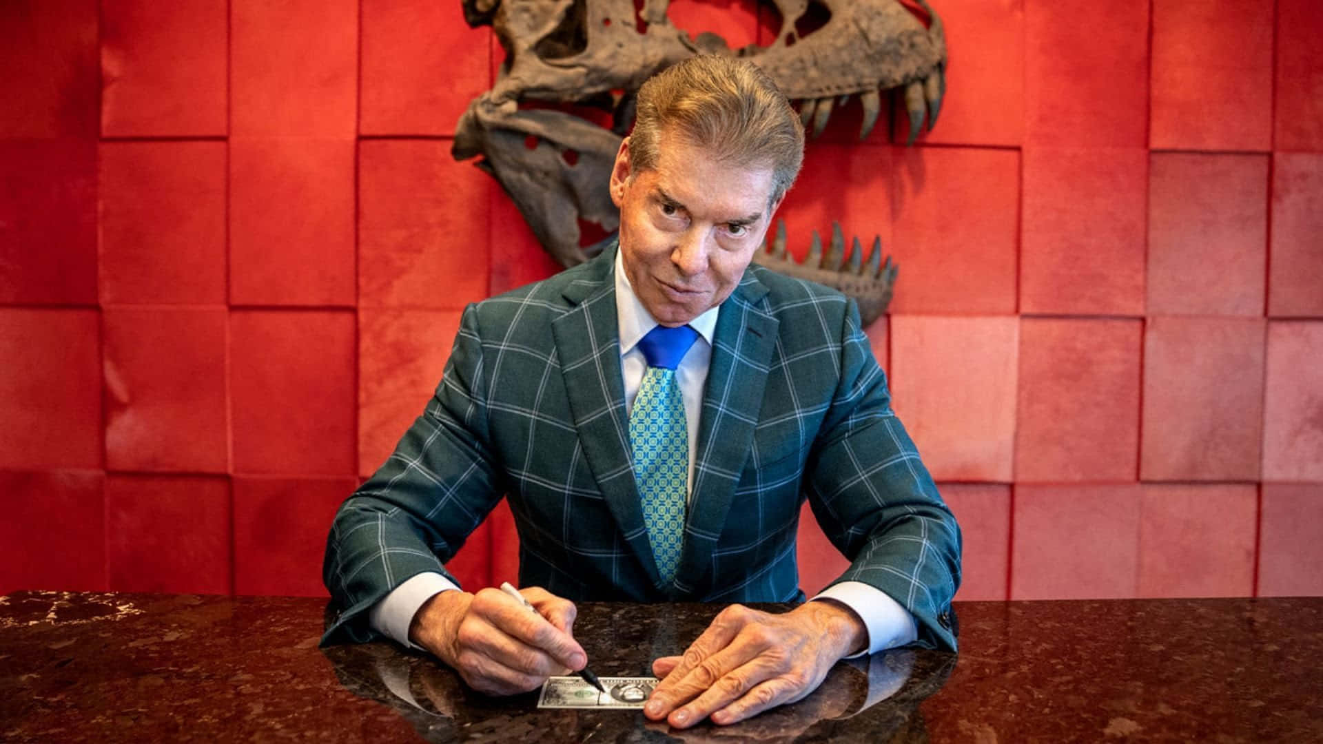 Wwe Ceo Vince Mcmahon Signing A Check Background