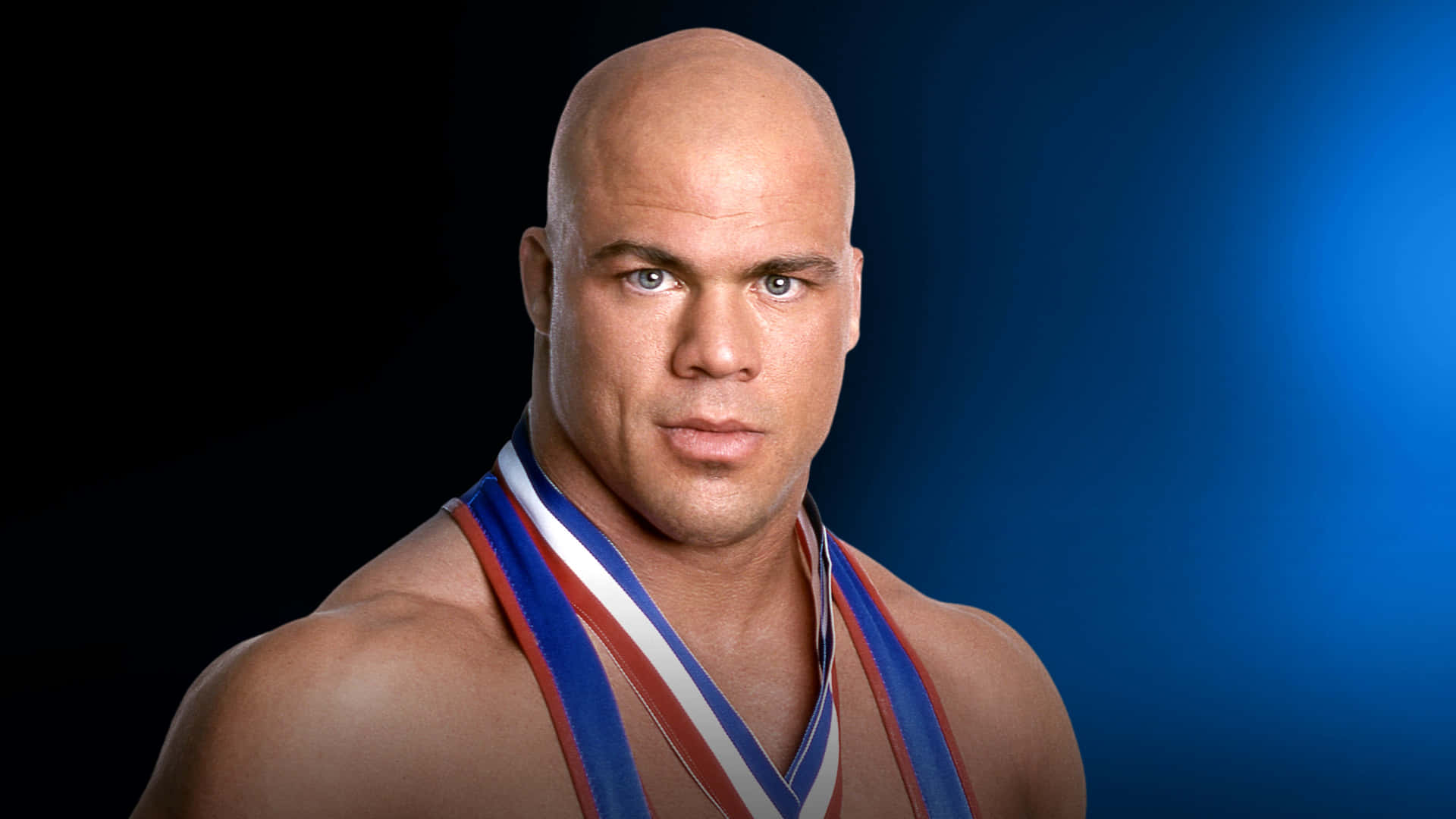 Wwe Hall Of Famer Kurt Angle Poses In Black And Blue Gradient Background Background