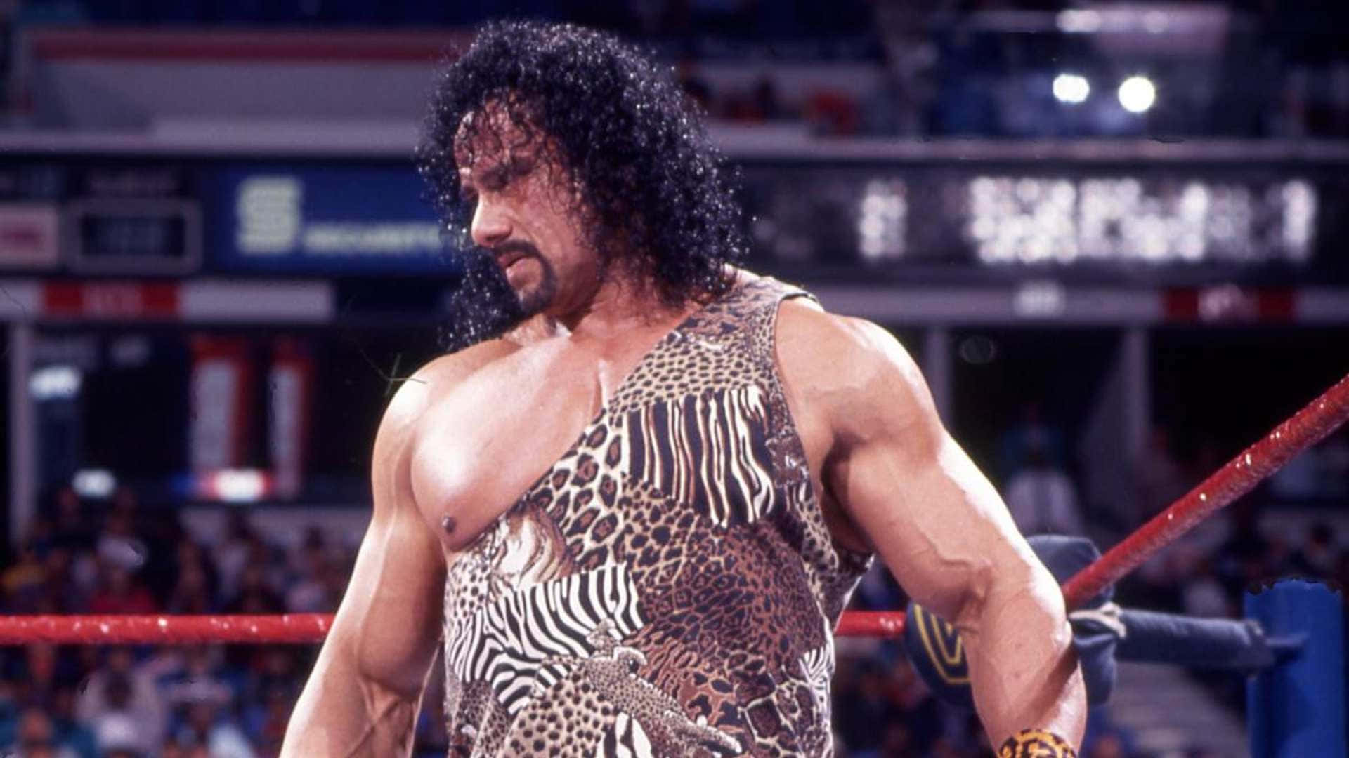 Wwe Legend Jimmy Snuka Showcasing His Signature Move Background