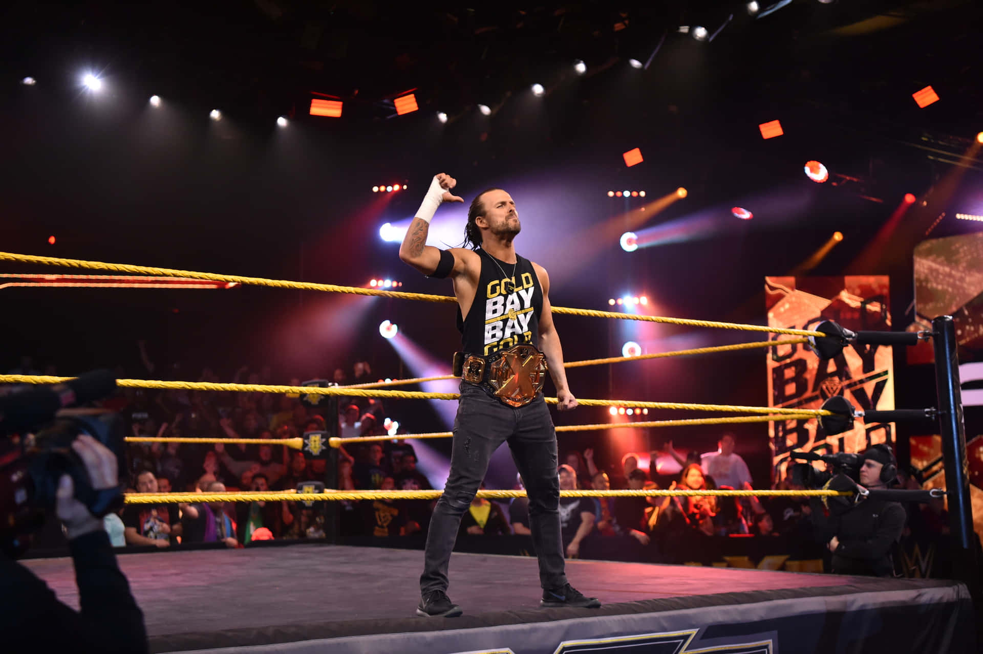 Wwe Nxt Adam Cole Standing Outside The Ring Background