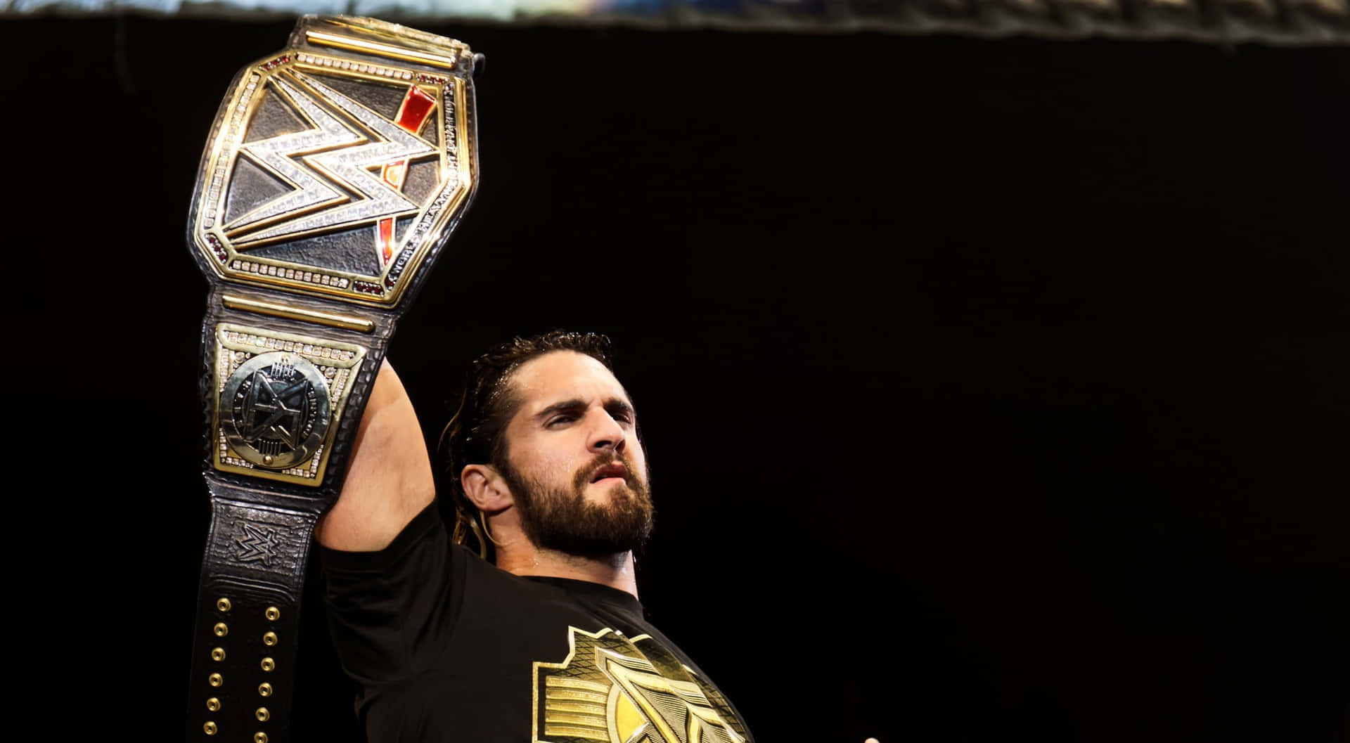 Wwe Wrestler Seth Rollins Raising His Belt Background