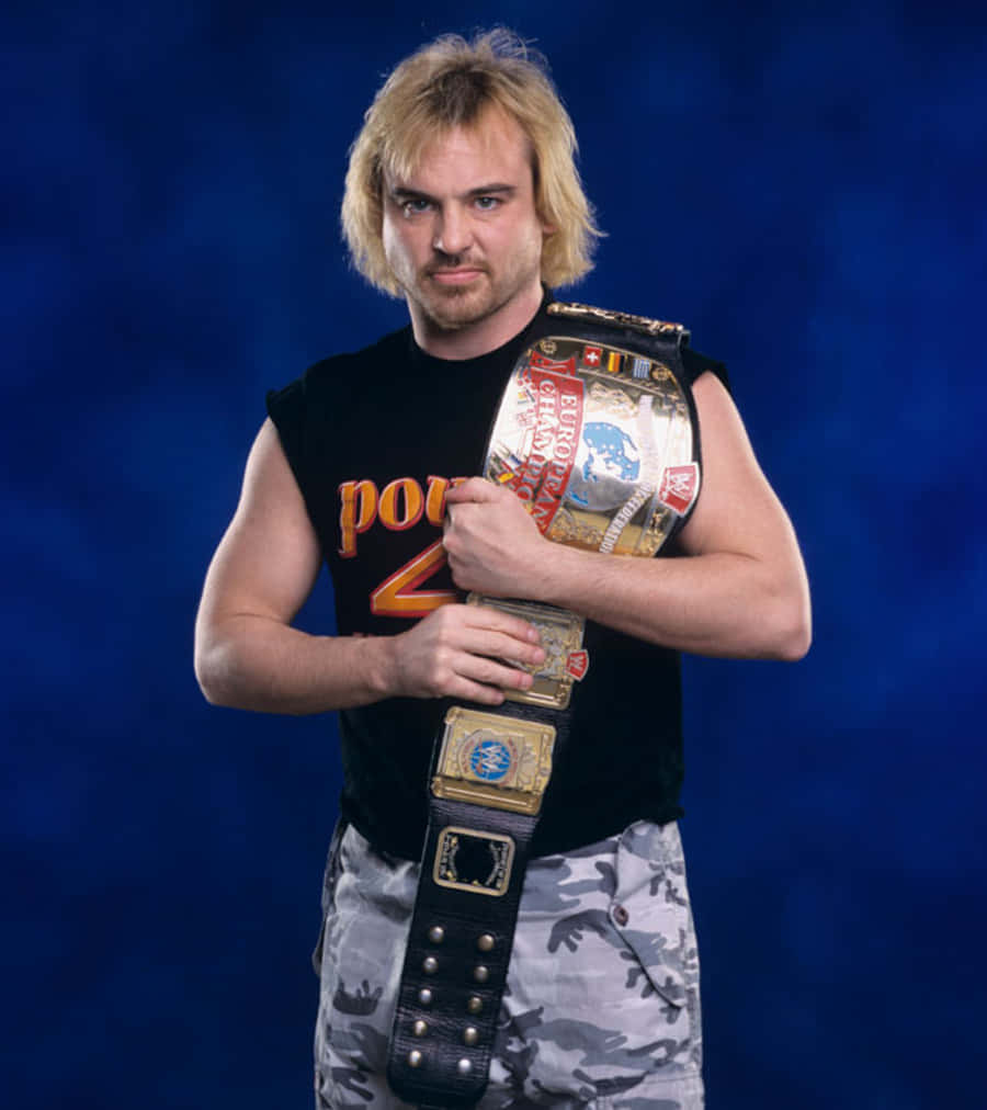 Wwe Wrestler Spike Dudley Triumphantly Holding The European Championship Belt. Background