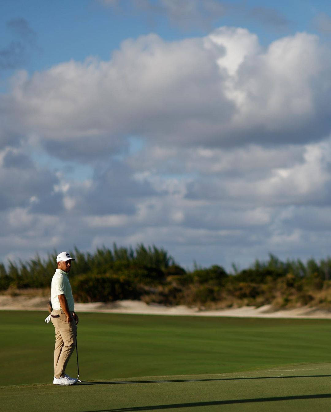 Xander Schauffele Standing On Golf Course Background