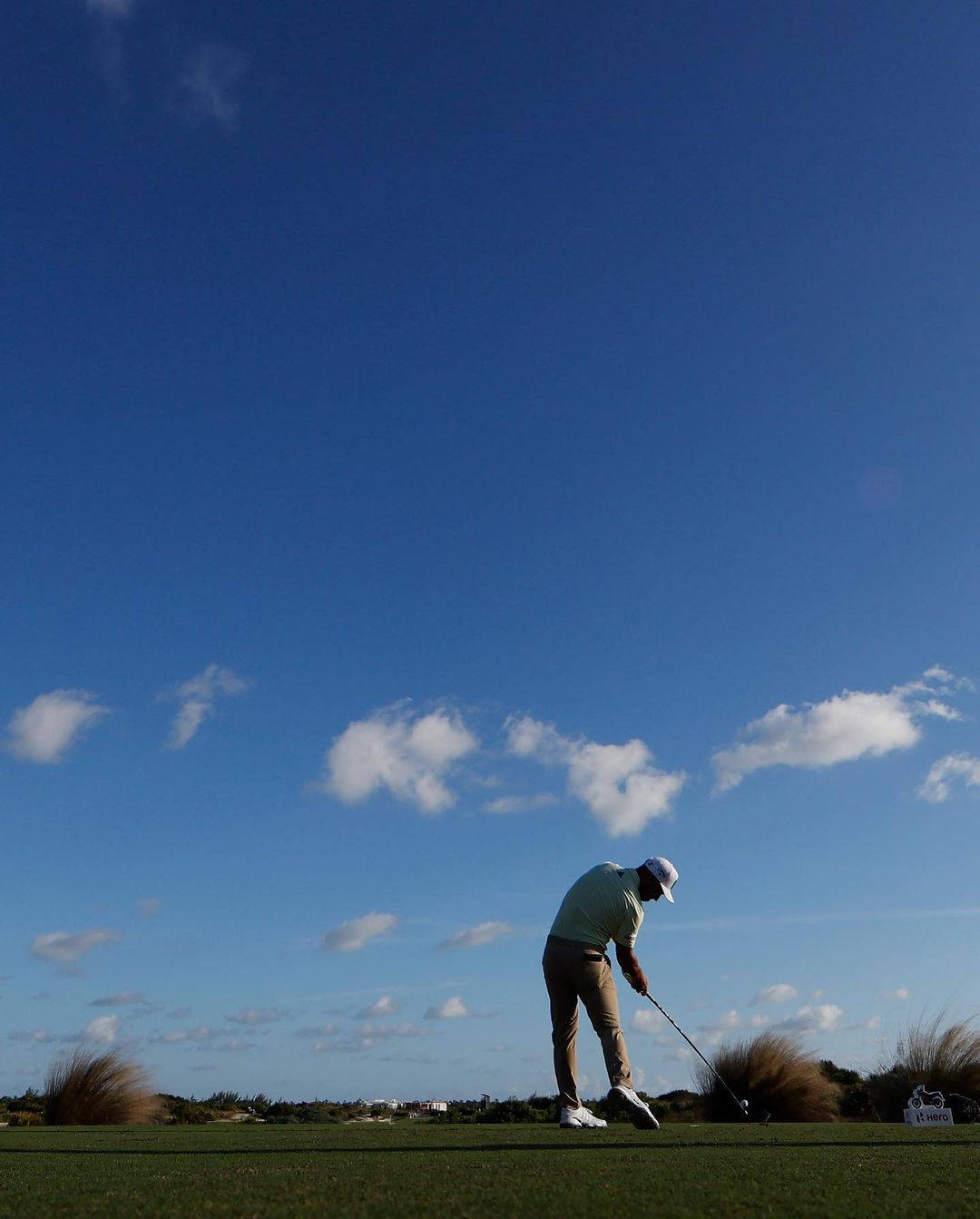 Xander Schauffele Under Clear Blue Skies Background