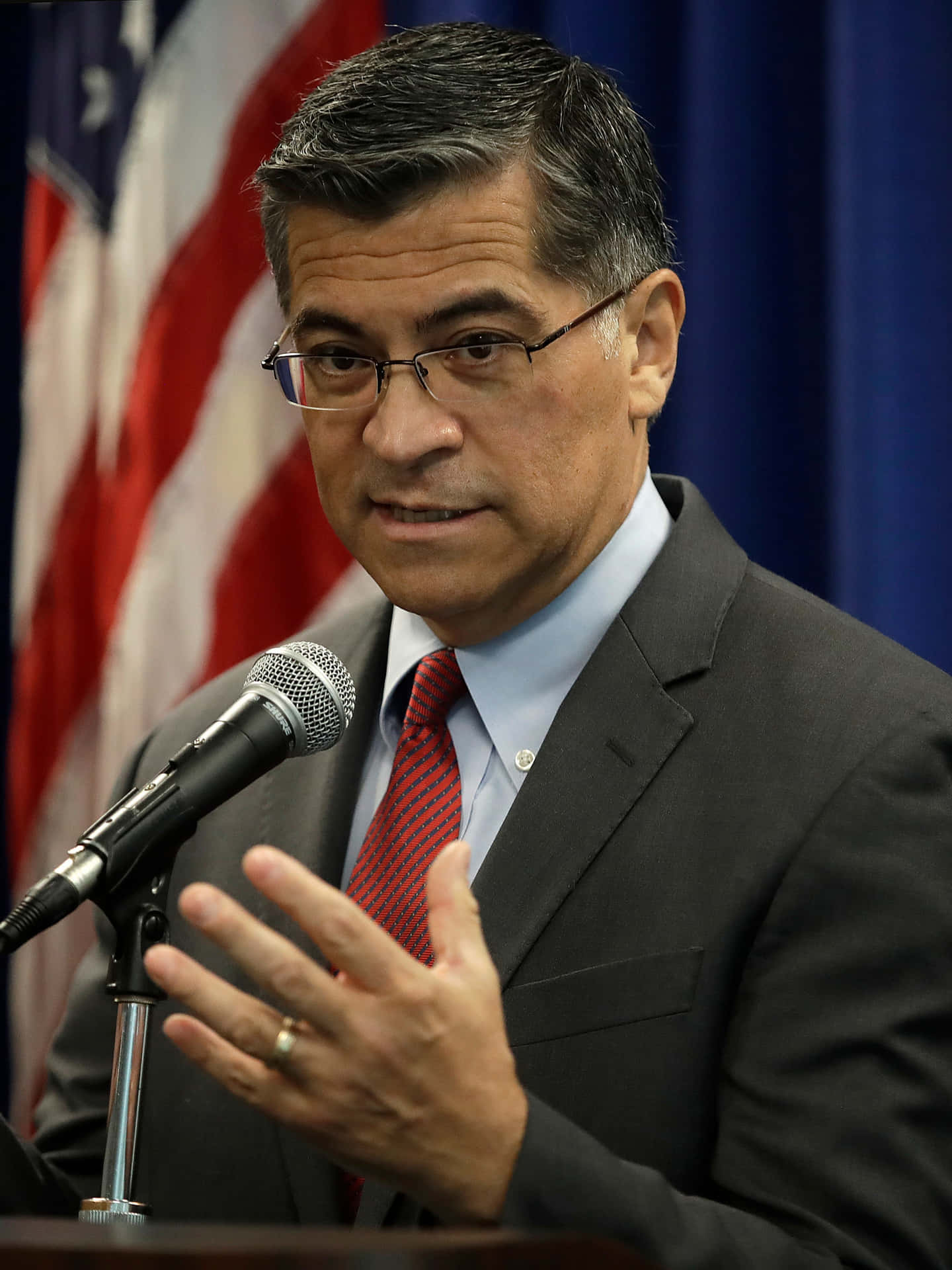 Xavier Becerra Delivering A Speech Portrait Background