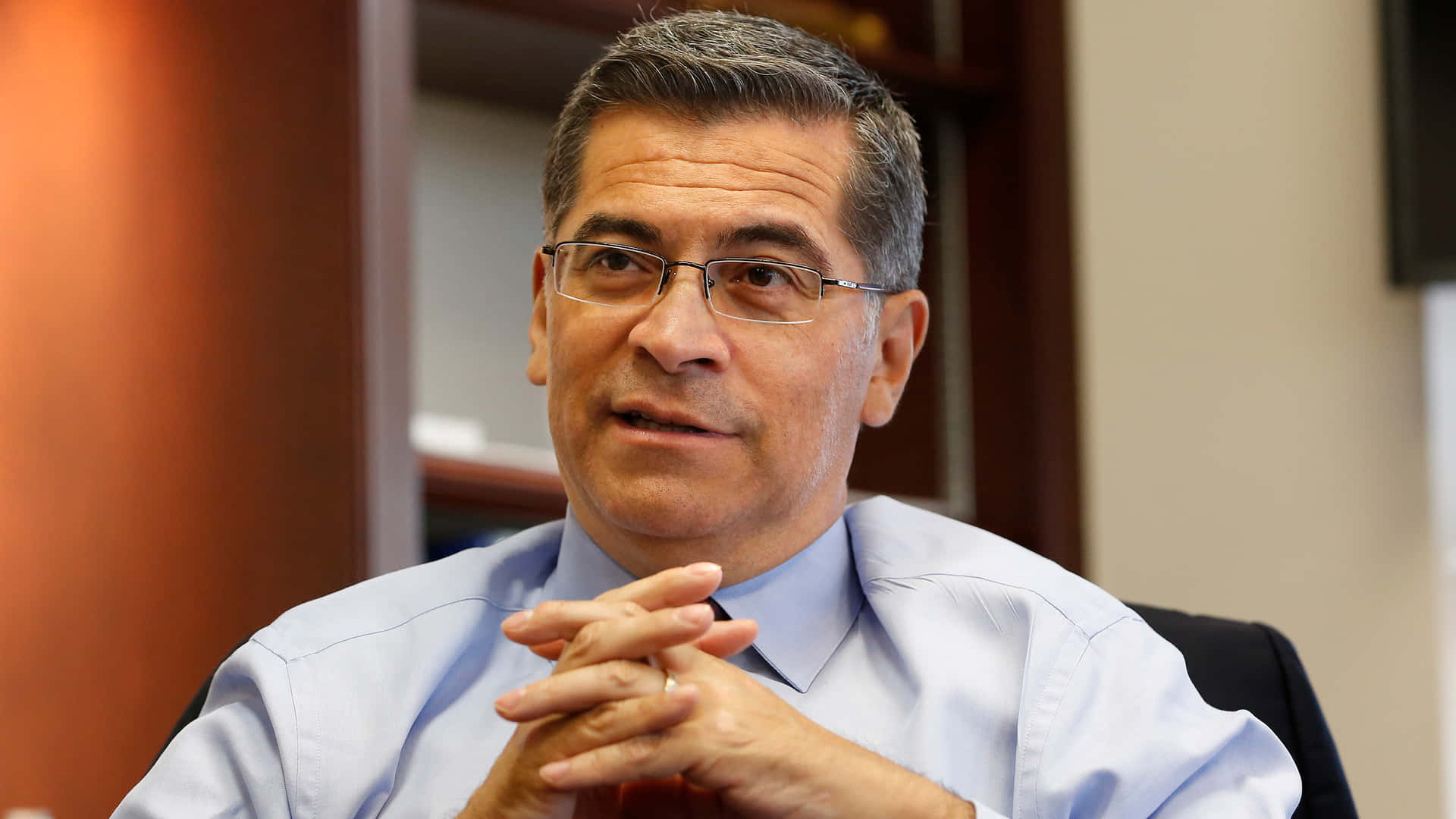 Xavier Becerra Hands Clasped Background
