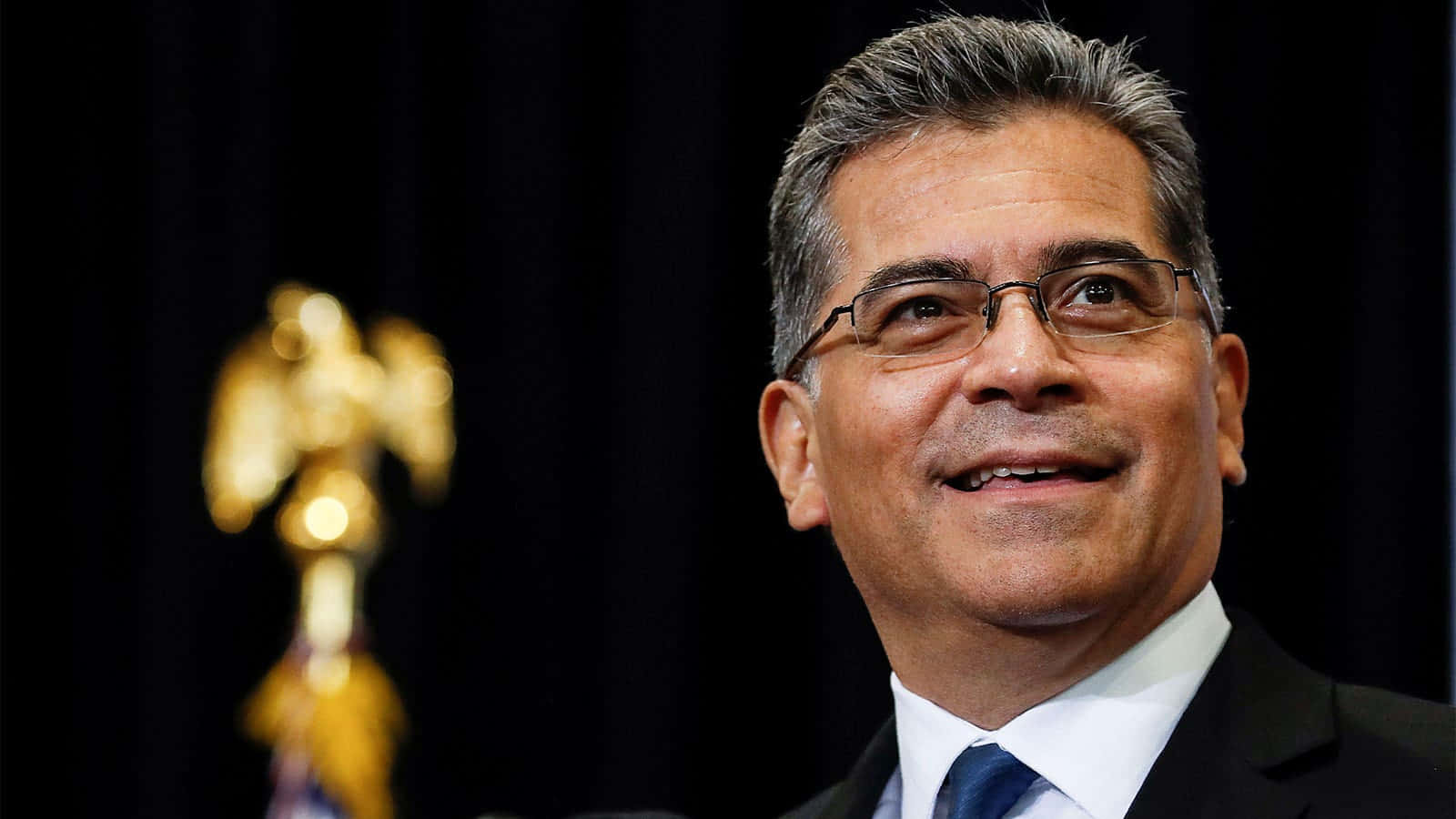 Xavier Becerra Smiling Calmly Background