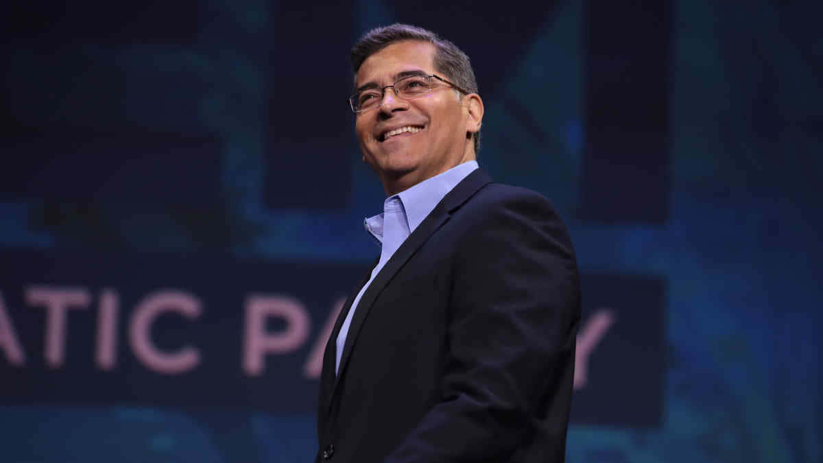 Xavier Becerra Smiling For A Low Angle Photo Background