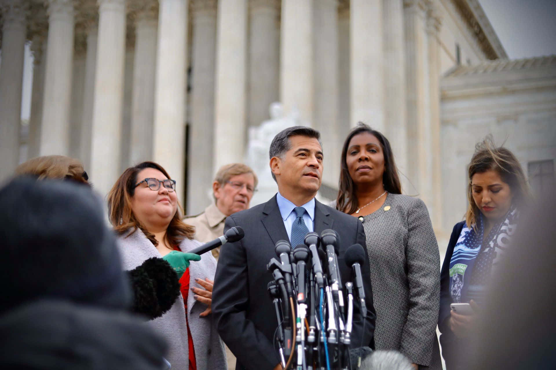 Xavier Becerra Surrounded By People Background