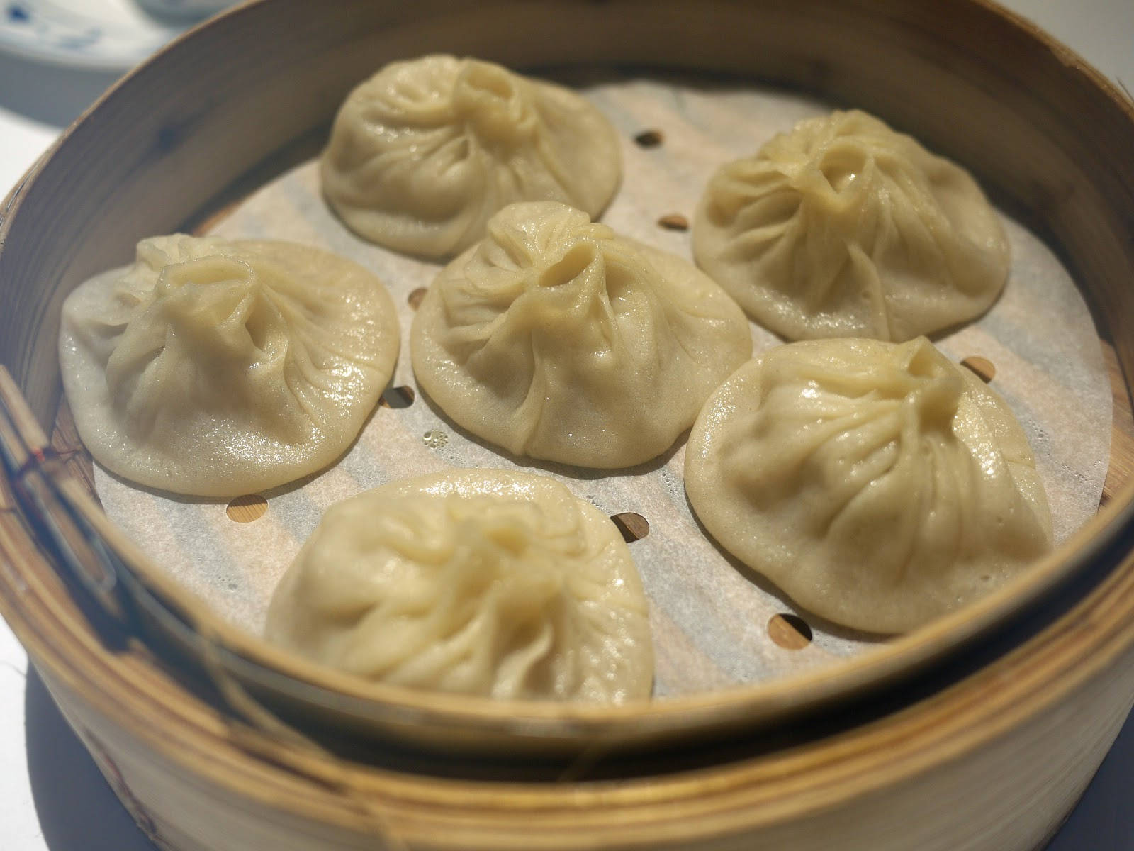 Xiaolongbao On A Traditional Bamboo Steamer Background