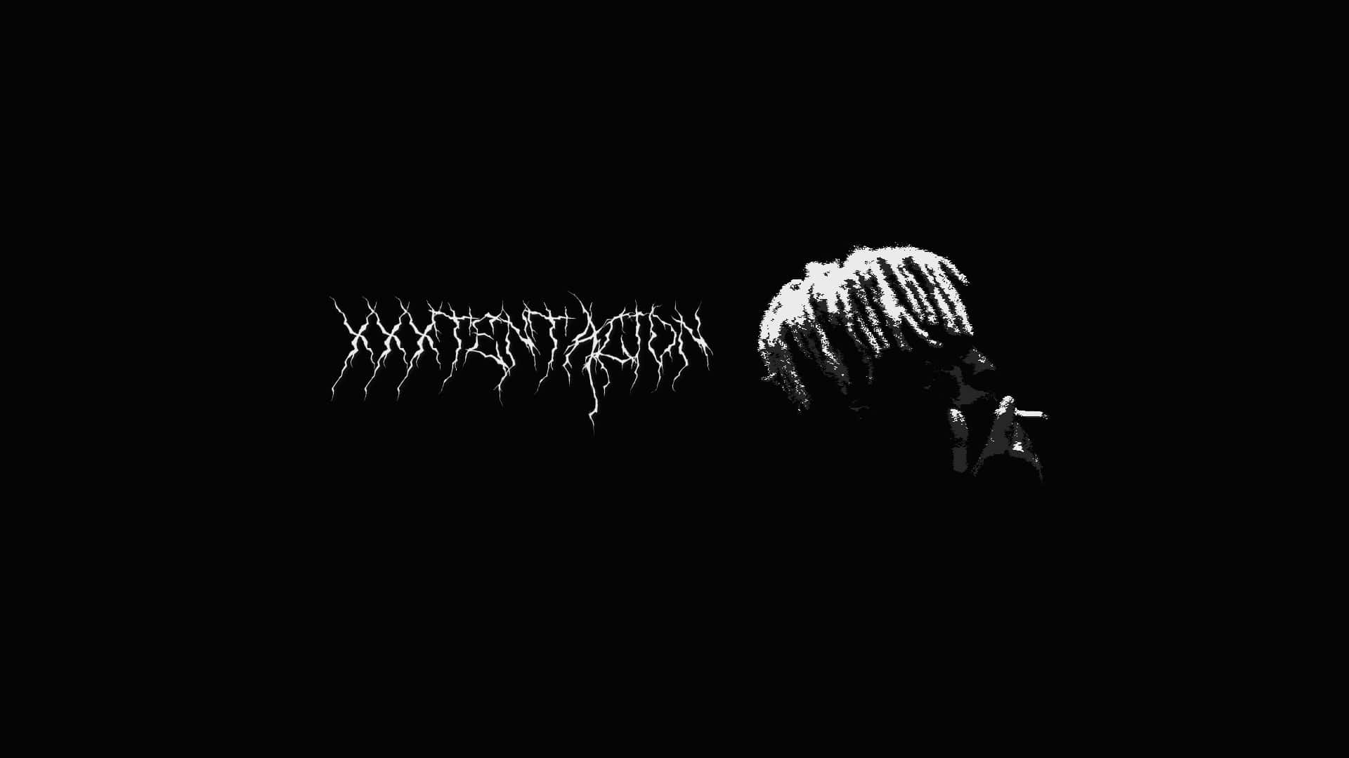 Xxxtentacion Using A Laptop In A Creatively Set Environment Background