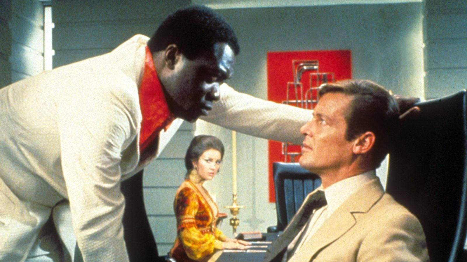 Yaphet Kotto And Roger Moore Doing A Scene Background