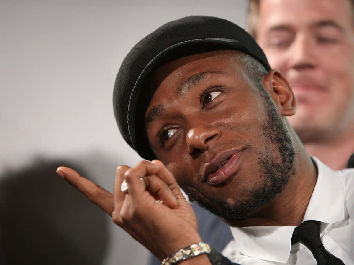 Yasiin Bey Looking Confident And Stylish Background