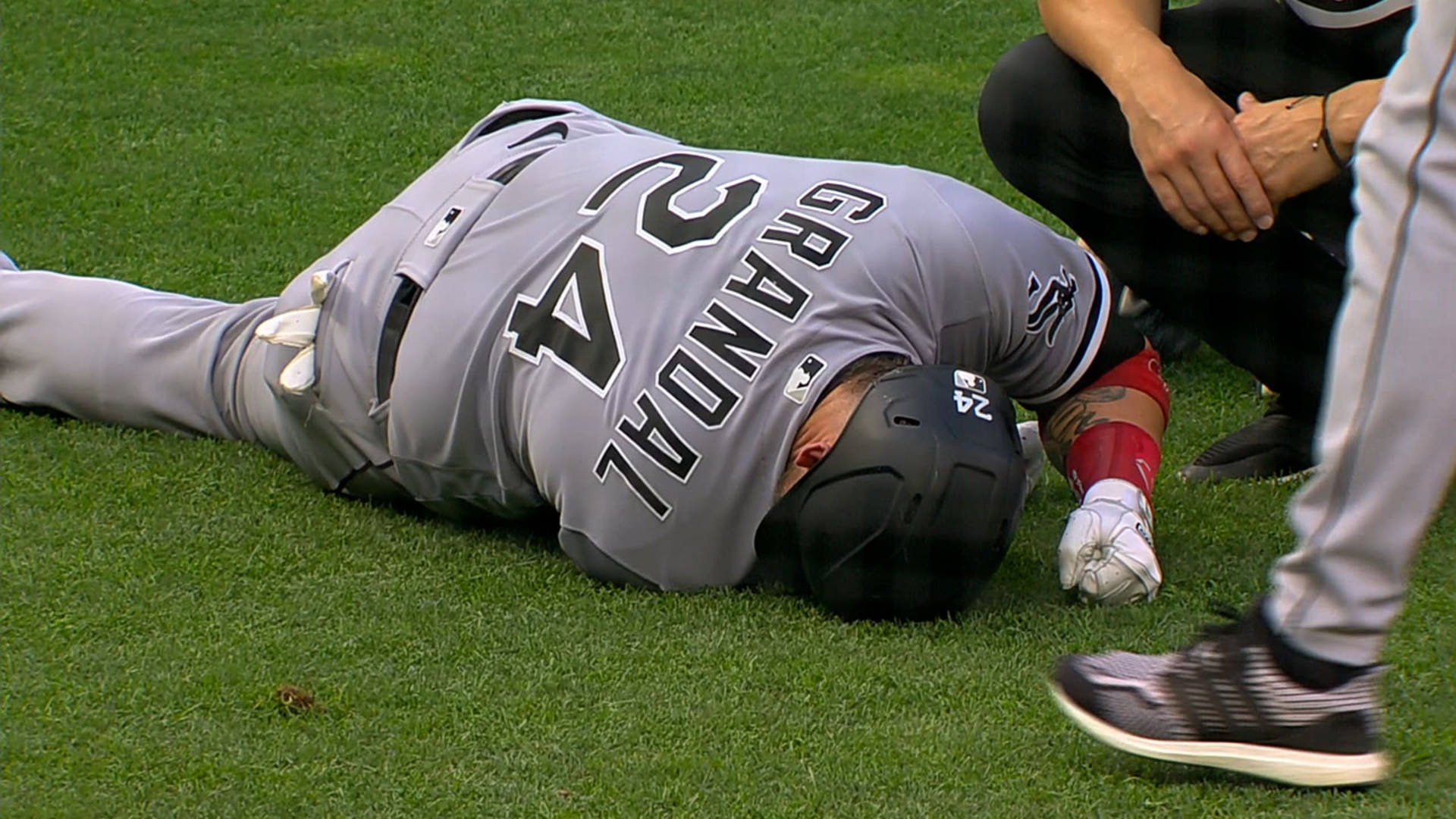 Yasmani Grandal Lying Down On Field Background