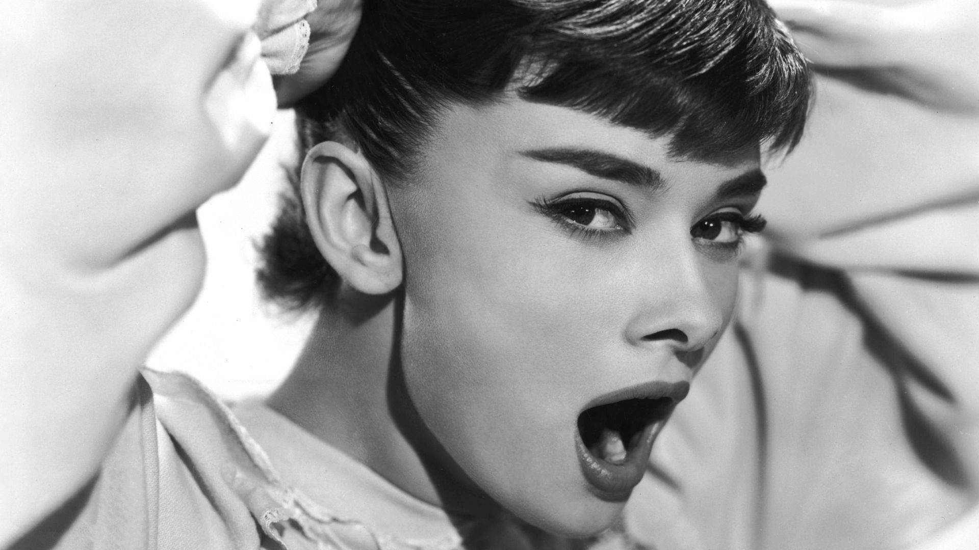 Yawning Beauty Audrey Hepburn Background