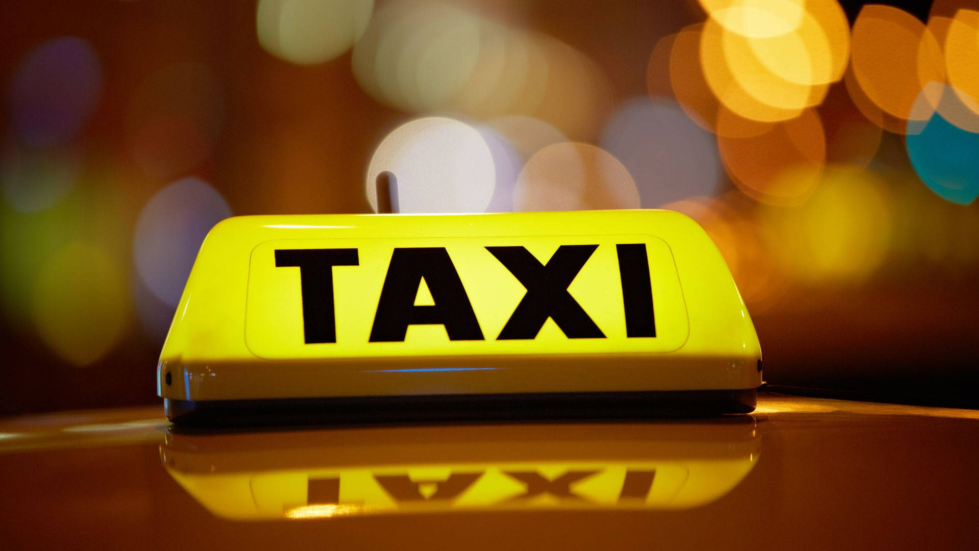Yellow And Black Taxi Sign With Light Background