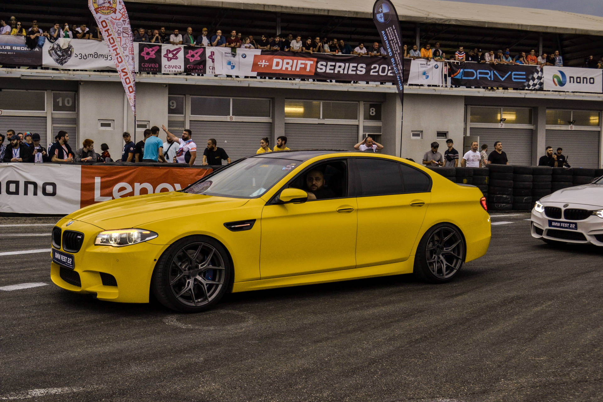 Yellow Bmw M5 At Racing Track Background