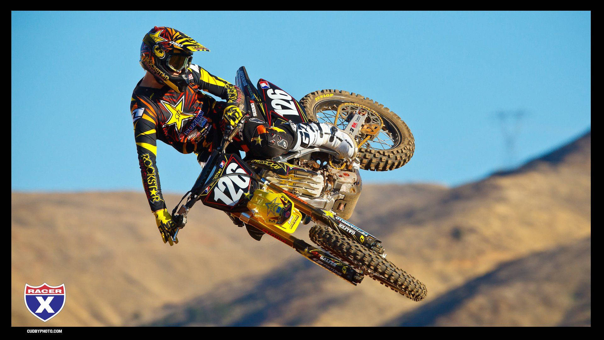 Yellow Dirt Bike In Action Background