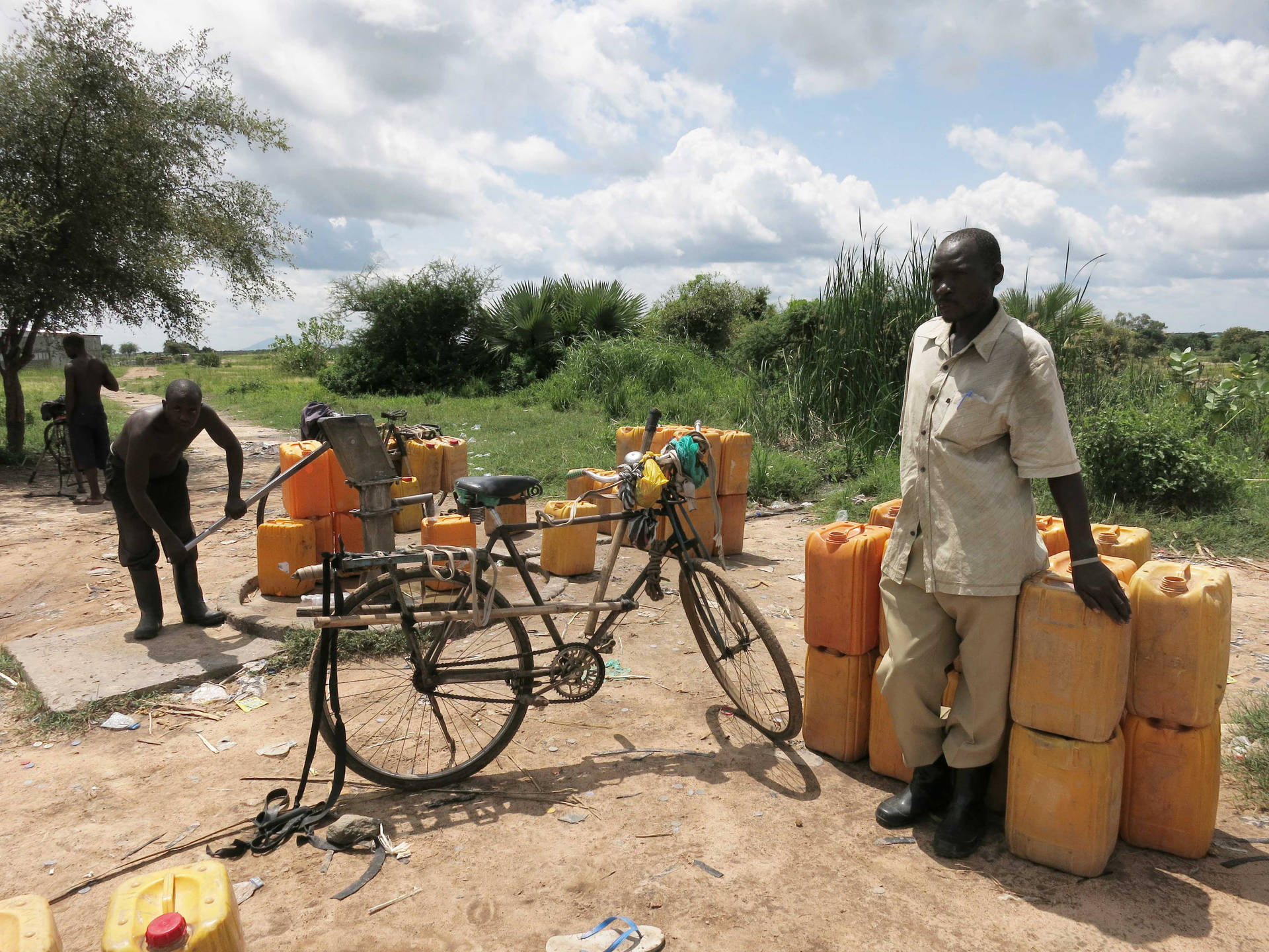 Yellow Jugs Lined Up In South Sudan Background