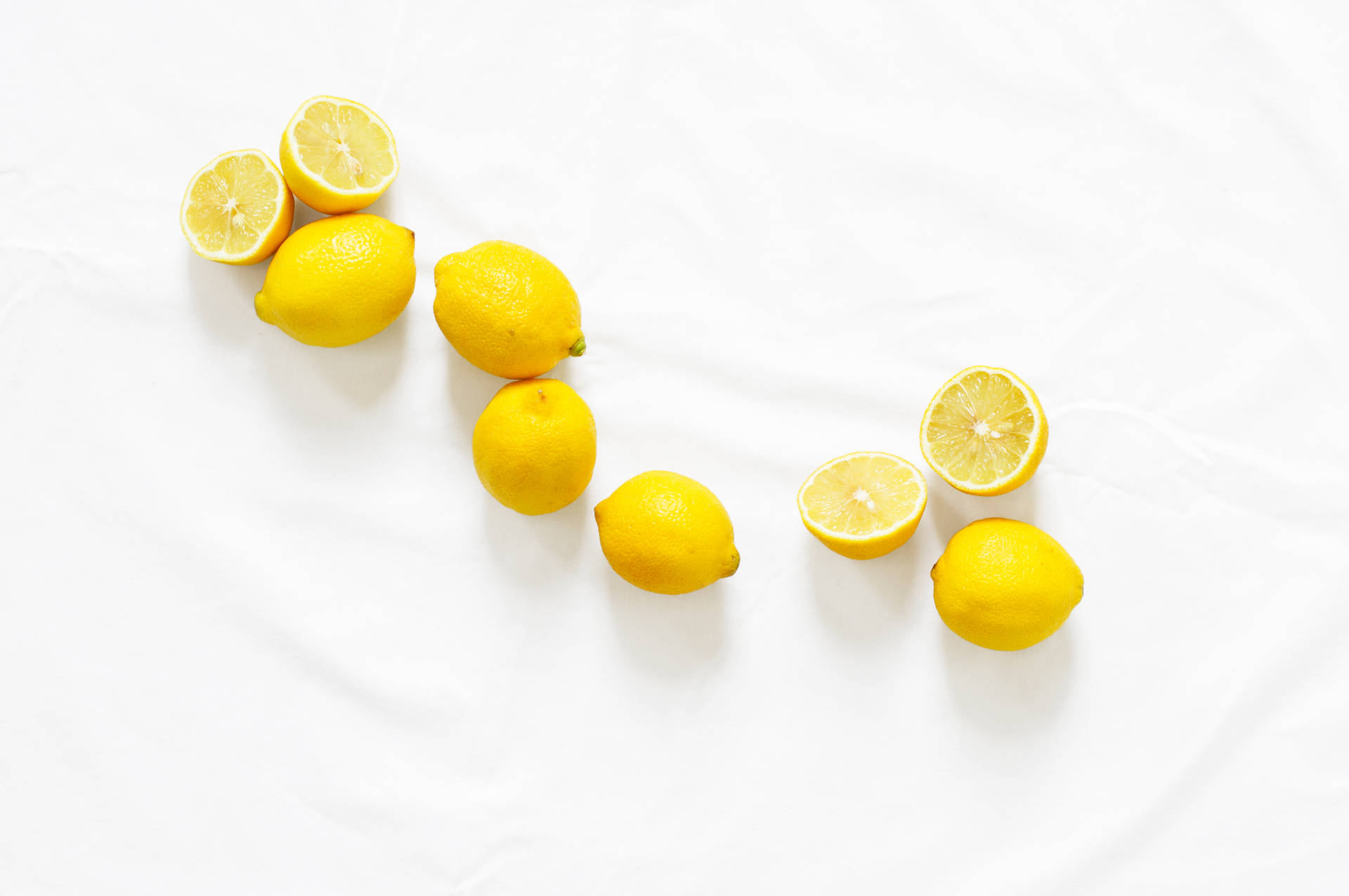 Yellow Lemons On White Surface Background