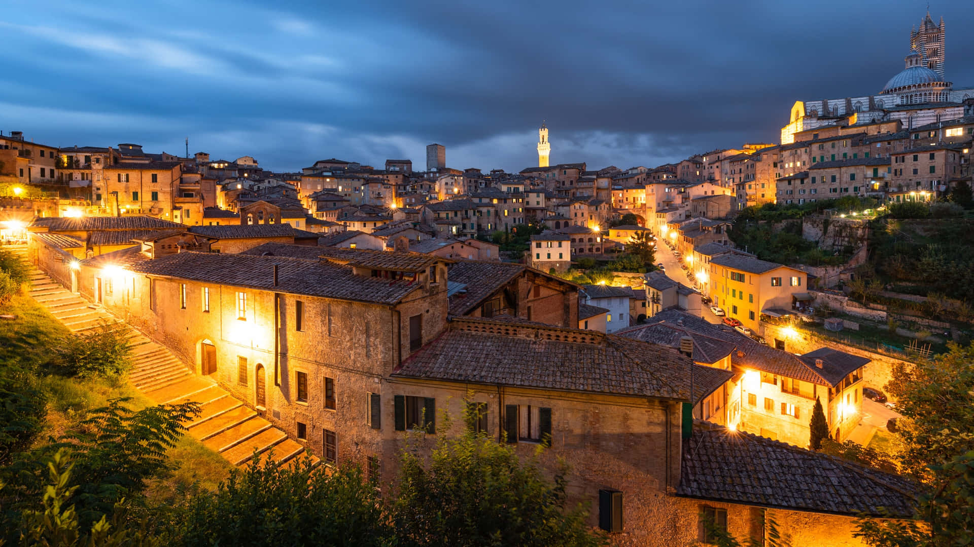 Yellow Lit Brick Houses In Siena Background