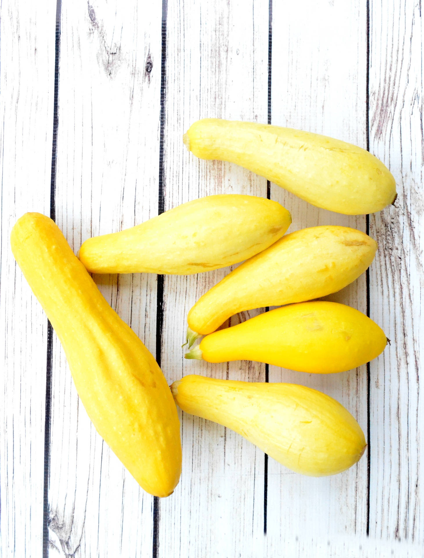 Yellow Squash On A White Wood Surface Background