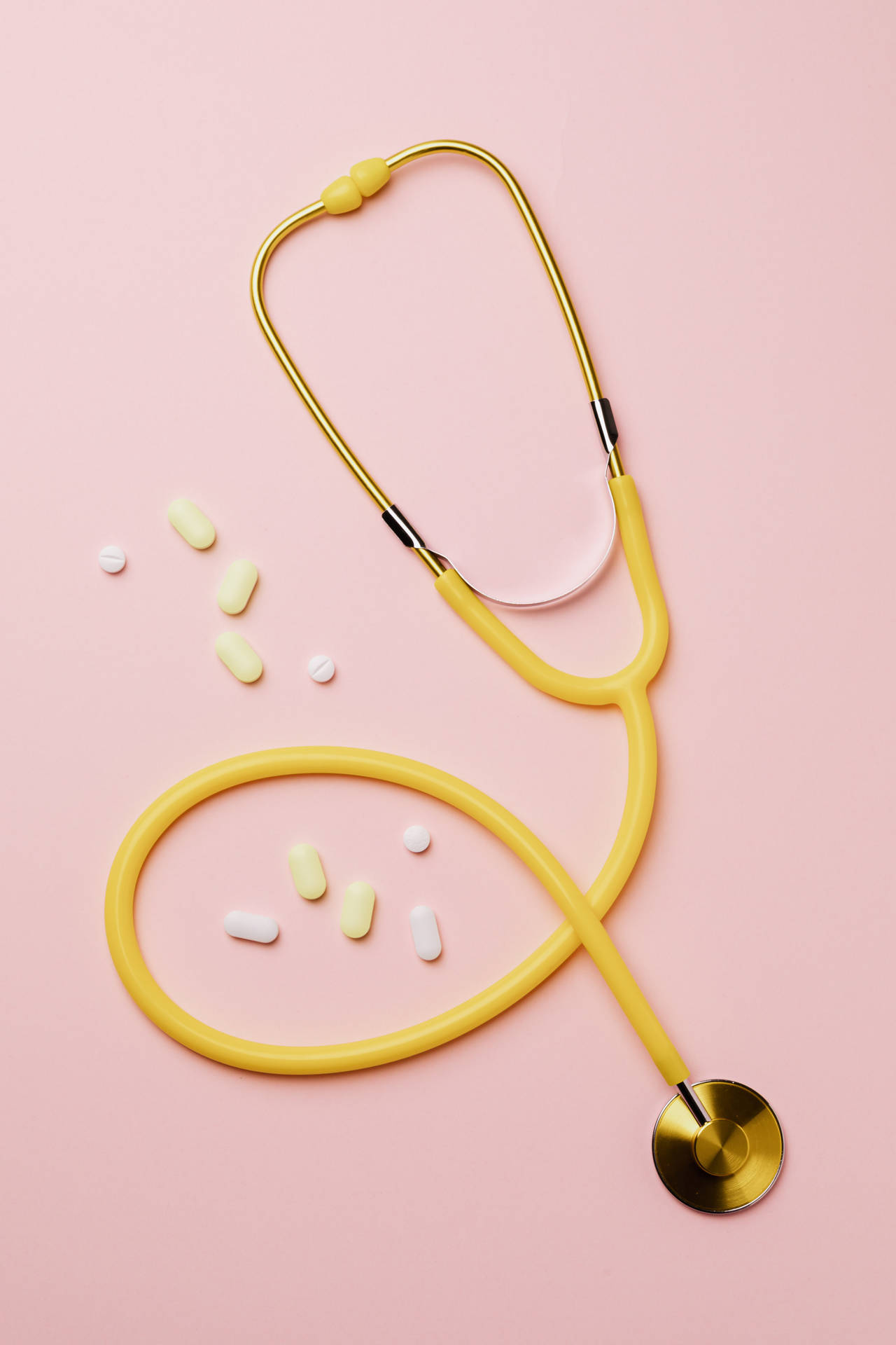 Yellow Stethoscope On Pink Background Background