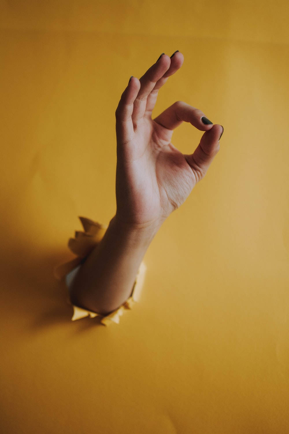Yellow Wall With Okay Hand Sign Background