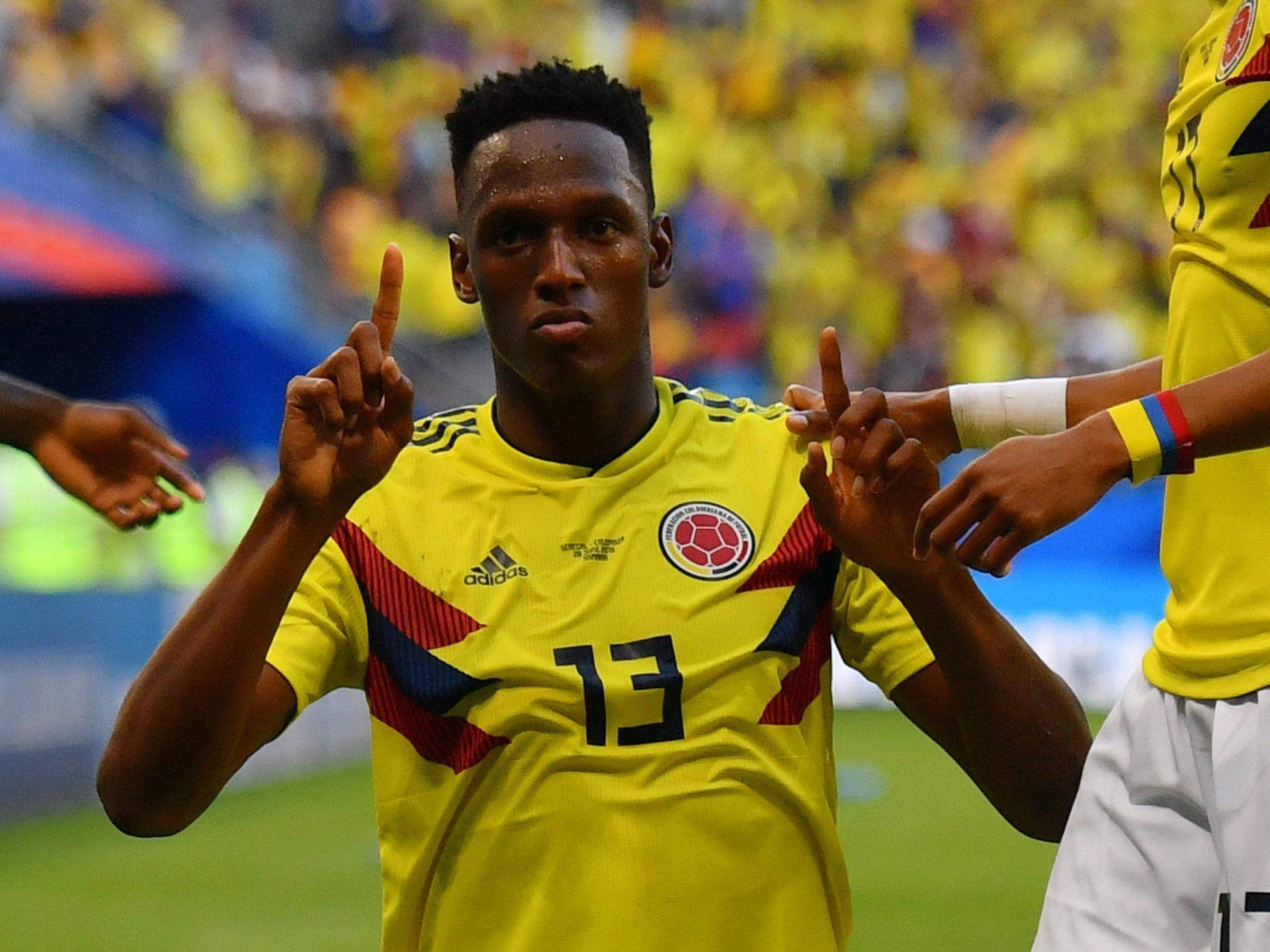 Yerry Mina Holding Pointer Fingers Up Background