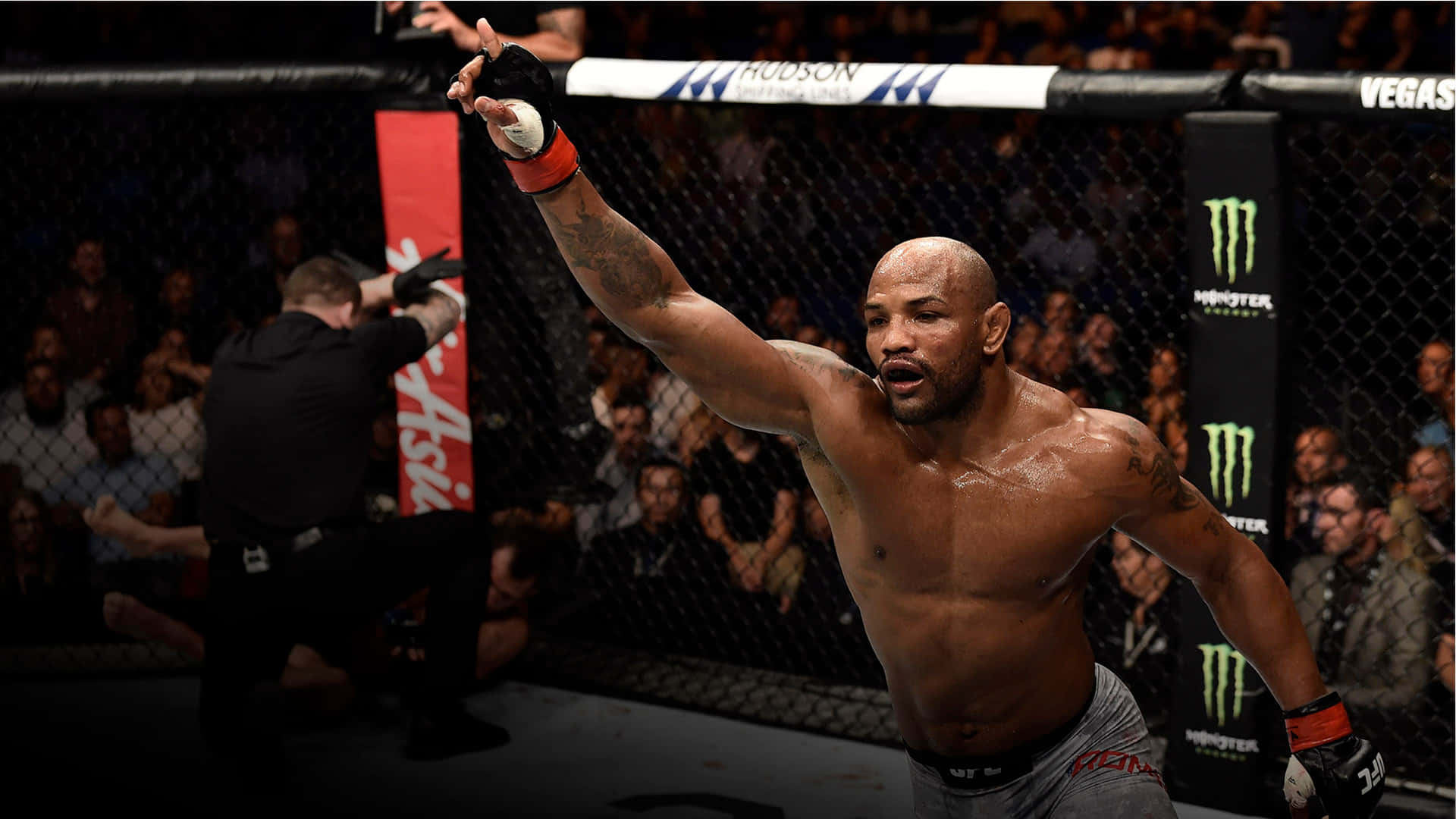 Yoel Romero Celebrating Victory Against Luke Rockhold At Ufc 221 Background