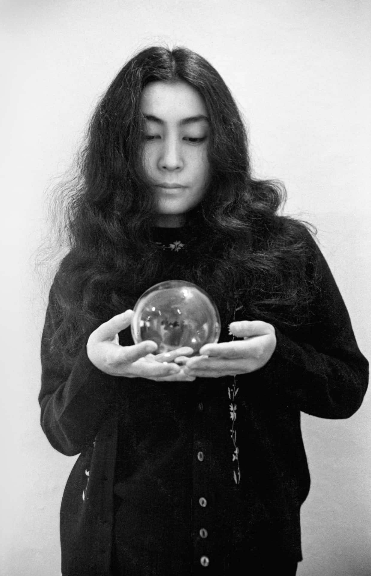 Yoko Ono Holding Sphere Background