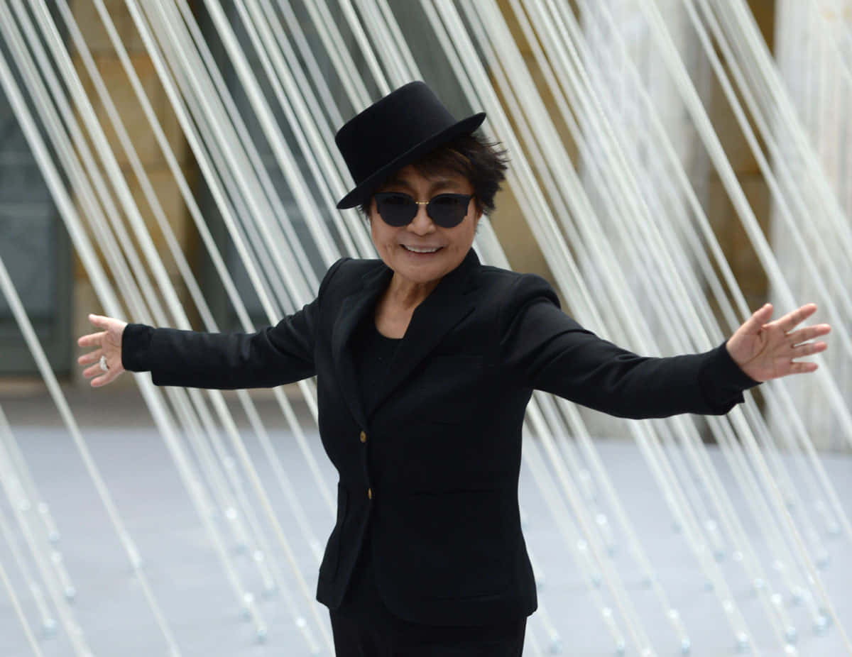 Yoko Ono Smiling Black Clothes Background