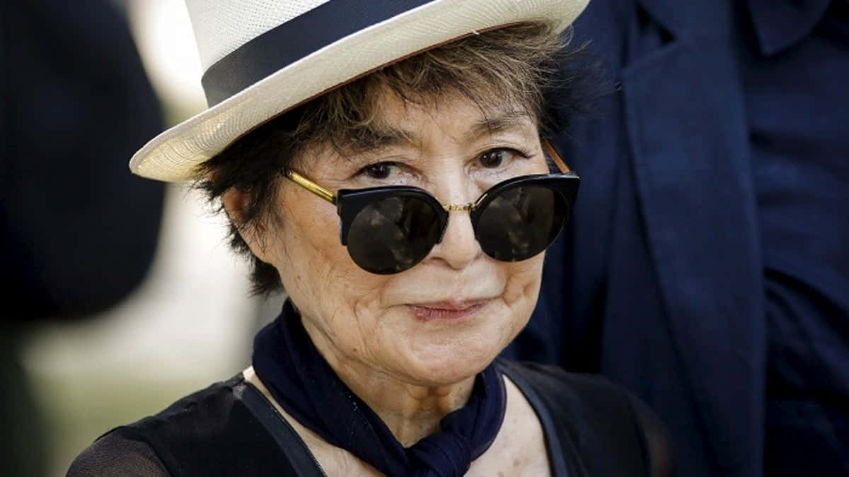 Yoko Ono Staring At Camera Background