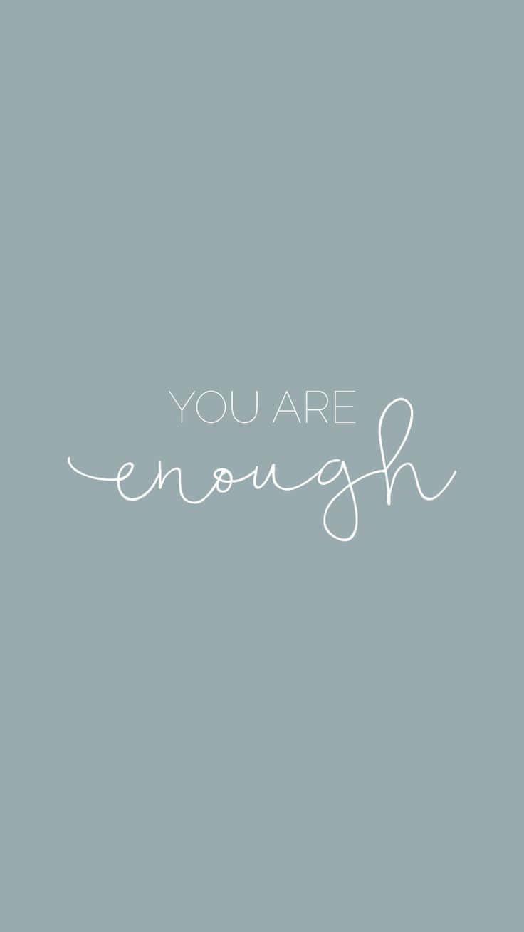 You Are Enough - A White Handwritten Quote On A Blue Background Background