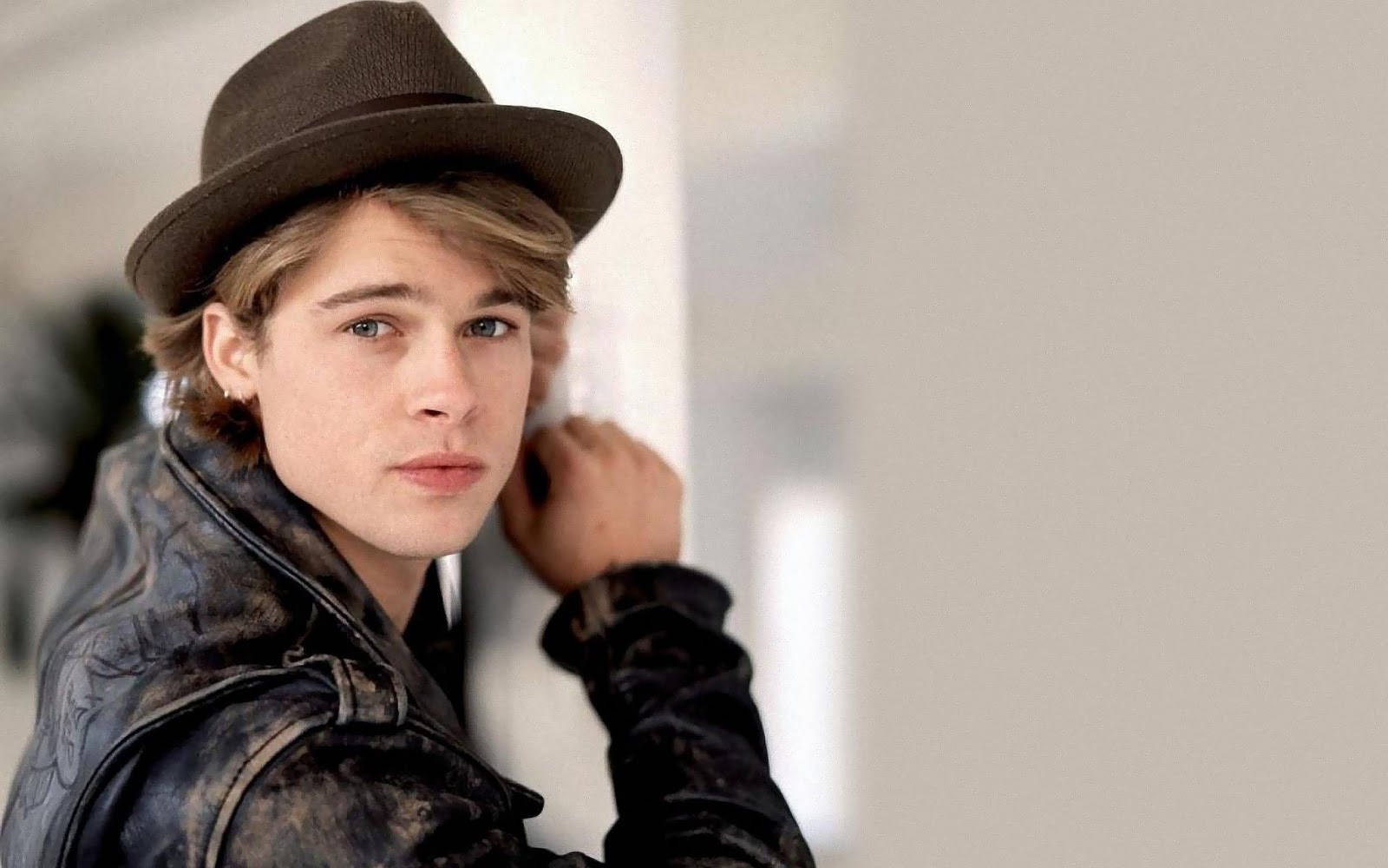 Young And Dapper Brad Pitt Wearing A Fedora Hat Background
