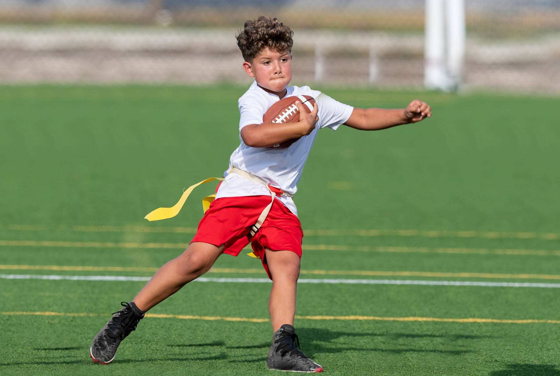 Young Boy At Youth Flag Football League Program Background