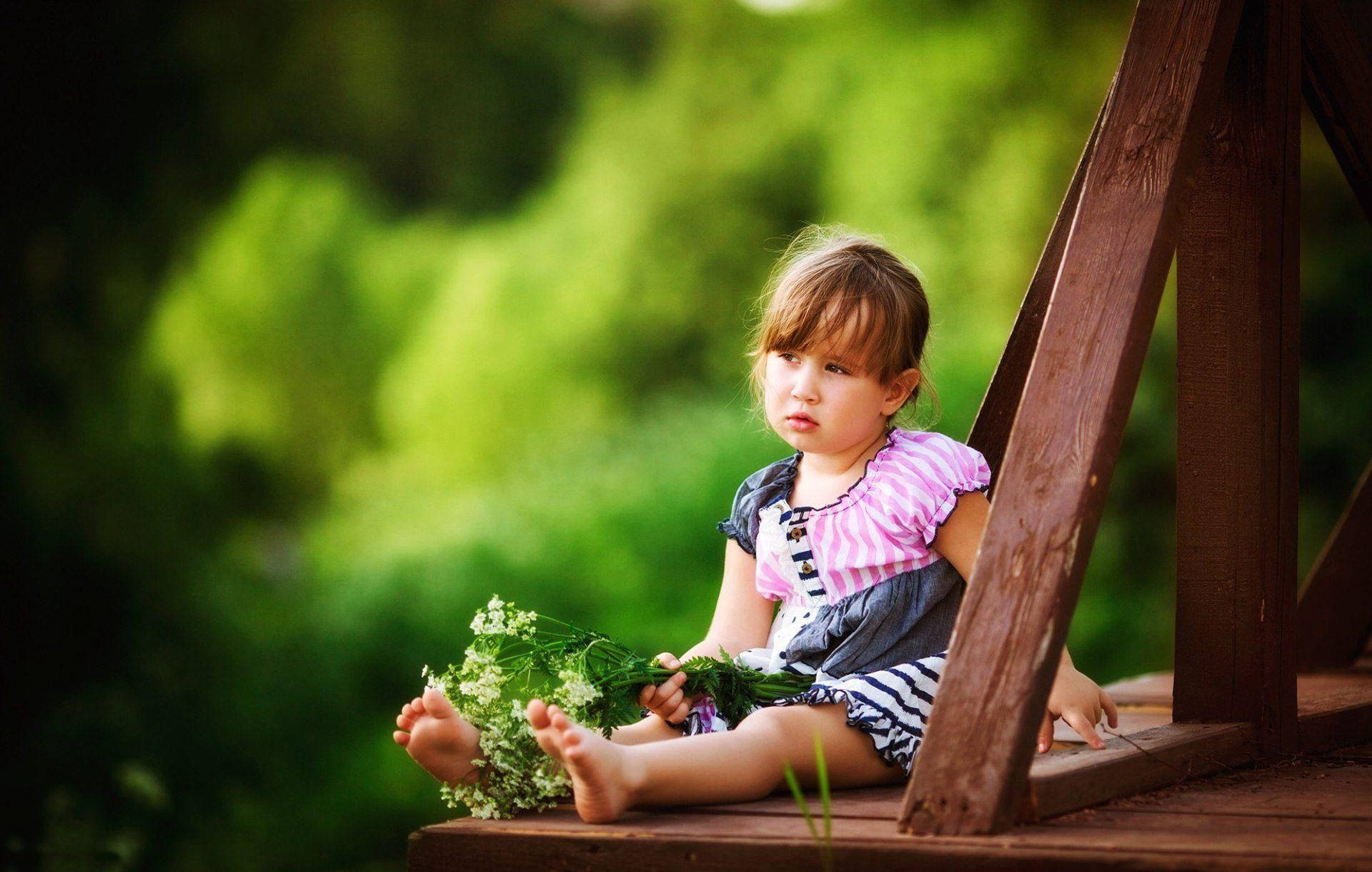 Young Child Holding A Bouquet Of Flowers Background