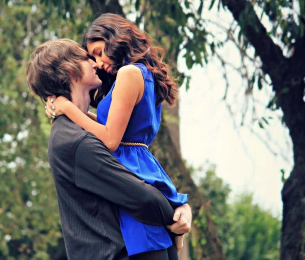 Young Couple In Love Embracing In An Intimate Moment Background