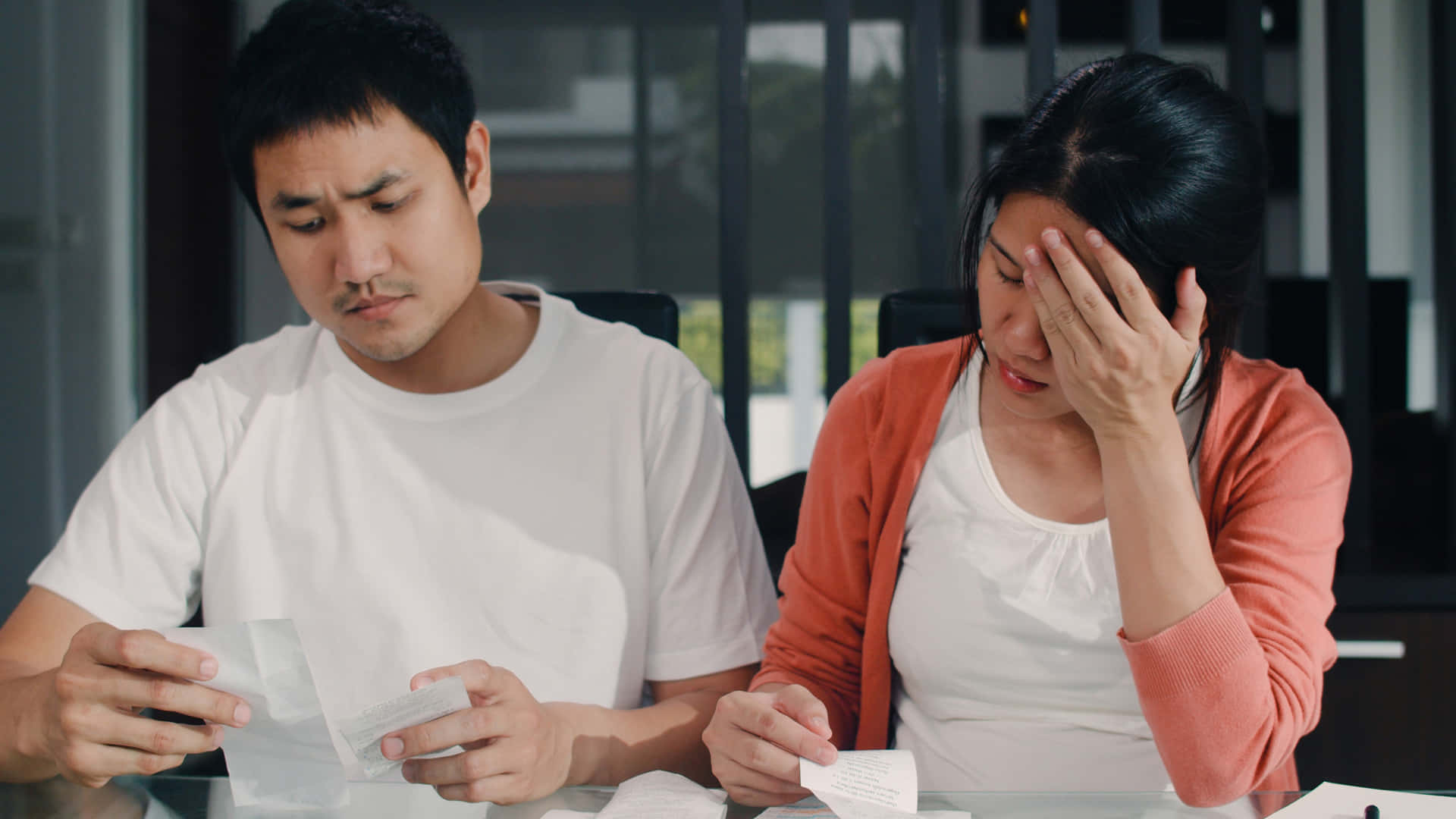 Young Couple Perturbed By Bills Background