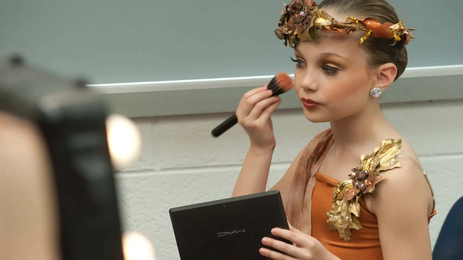 Young Dancer Applying Makeup Backstage Background