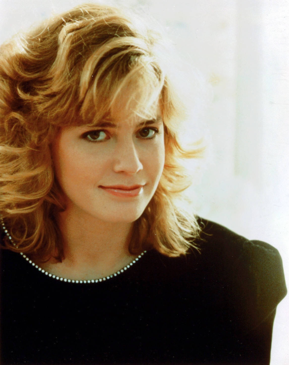 Young Elisabeth Shue Wearing Black Puffed Sleeve Top With Side Bangs Background