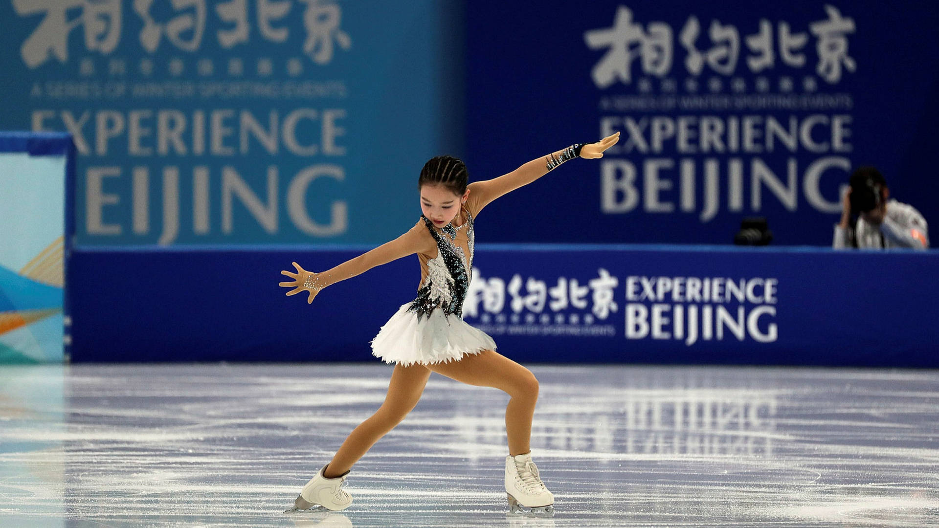 Young Female Skater At Winter Olympics Background