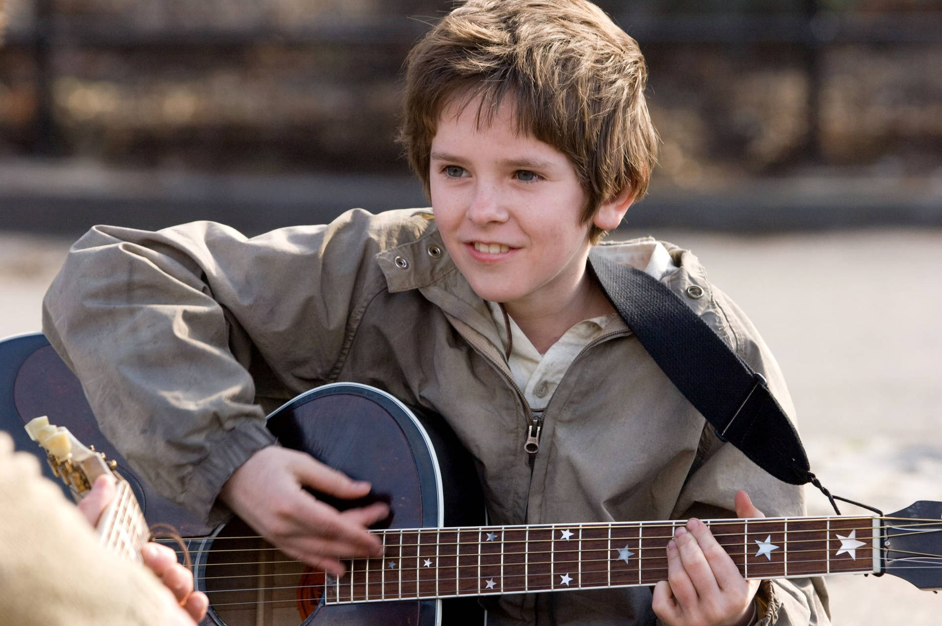 Young Freddie Highmore Playing Guitar Background