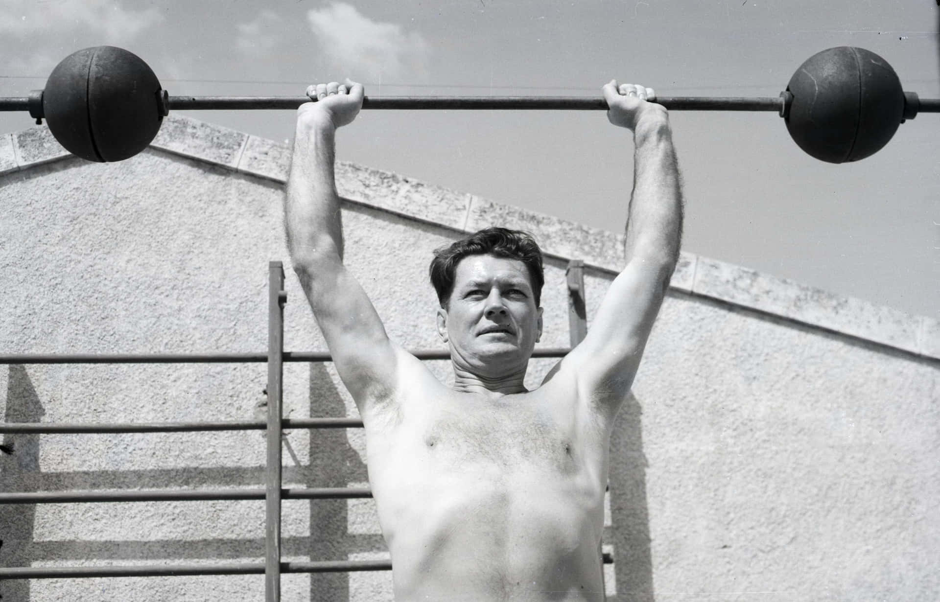 Young Gene Tunney Lifting Dumbbells Background
