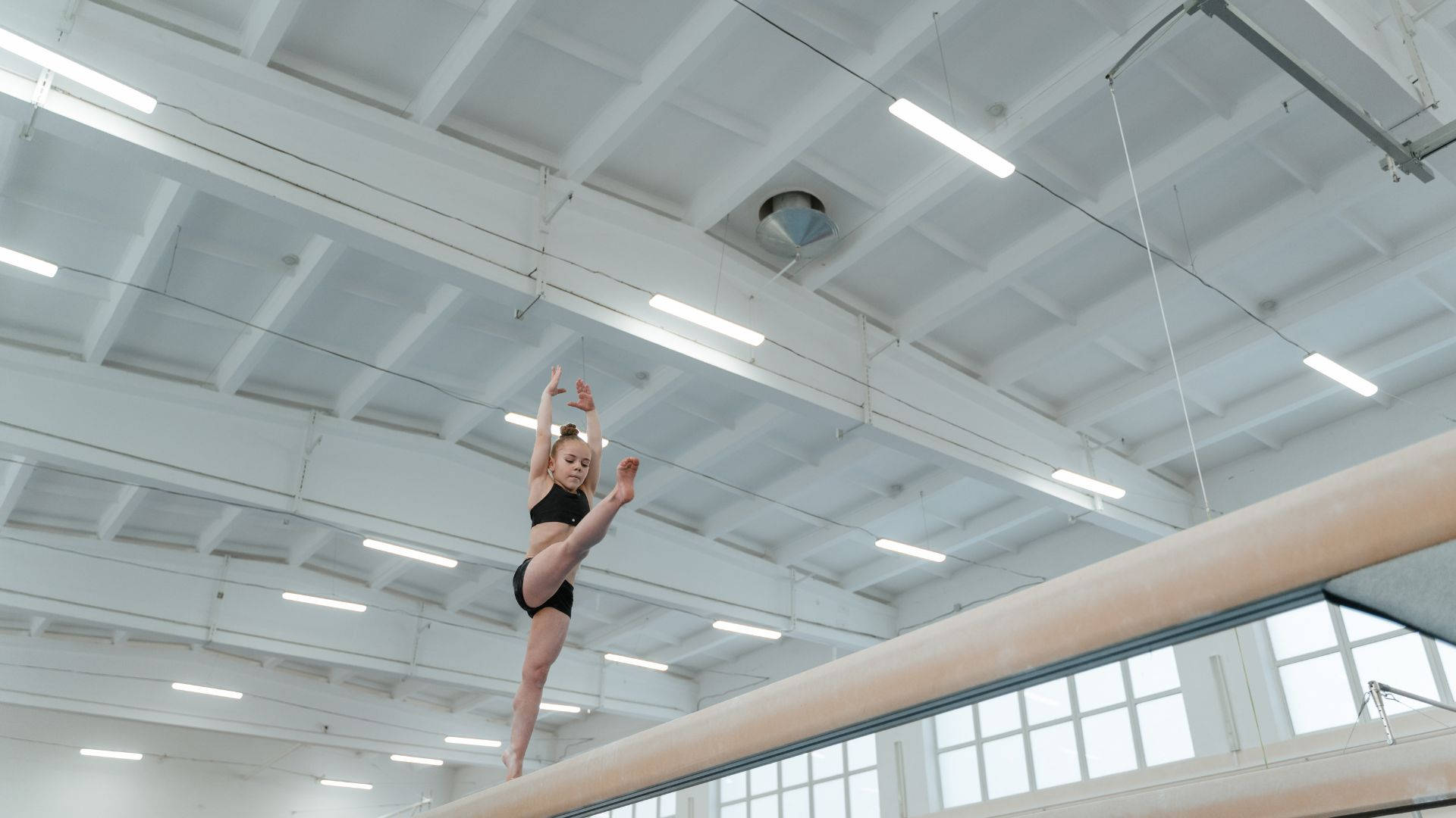 Young Girl Balancing On Balance Beam