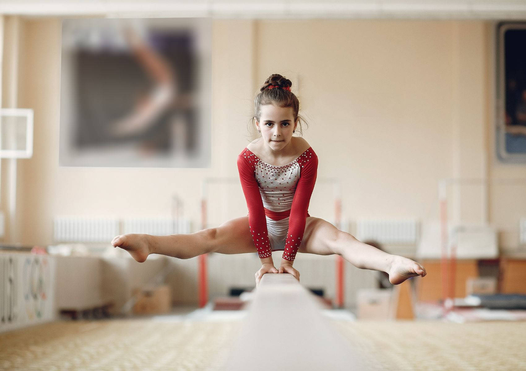 Young Girl Gymnast On The Balance Beam Background