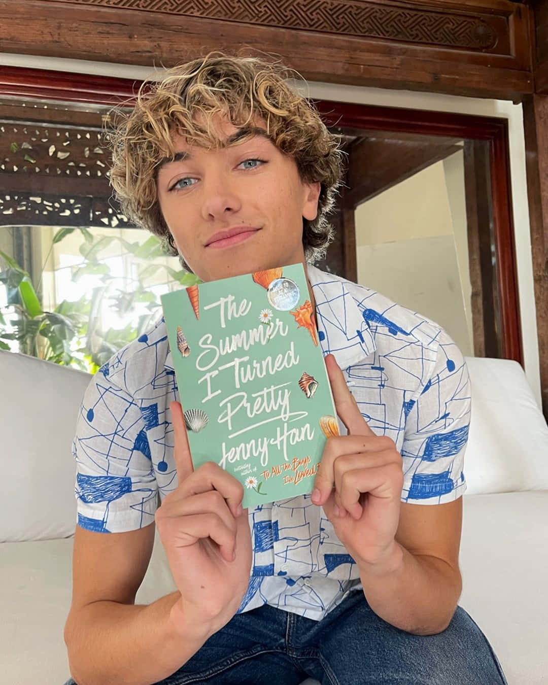 Young Man Holding Book The Summer I Turned Pretty Background