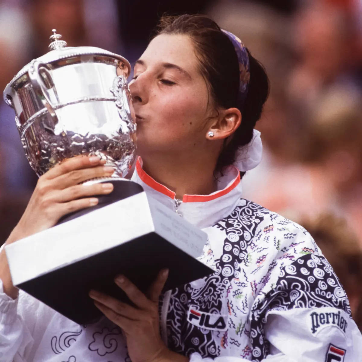 Young Monica Seles Kissing Her Trophy Background